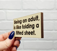 Load image into Gallery viewer, Being An Adult Is Like Folding A Fitted Sheet | Wooden Magnet | Magnet
